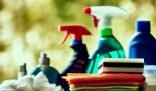 Various cleaning materials for home use including all-purpose cleaners, disinfectants, scrub brushes, sponges, and microfiber cloths.