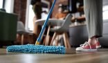 Close-up of a microfiber mop on a wooden floor, capturing the essence of deep cleaning for a thorough and sparkling home environment.
