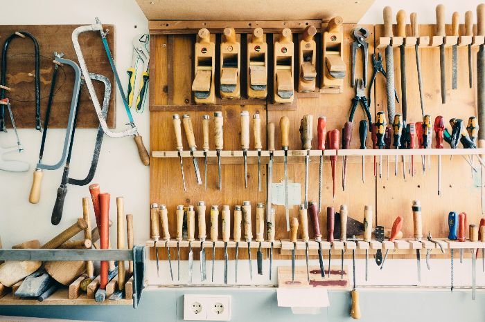 A neatly organized wall of various hand tools showcases the successful outcome of cleaning garages, reflecting the benefits of having a clean and orderly space not only for efficiency but also for the preservation of equipment.