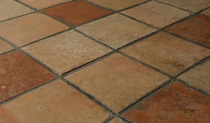 Stained ceramic and porcelain tiles showcasing the need for specialized cleaning techniques for floor care.