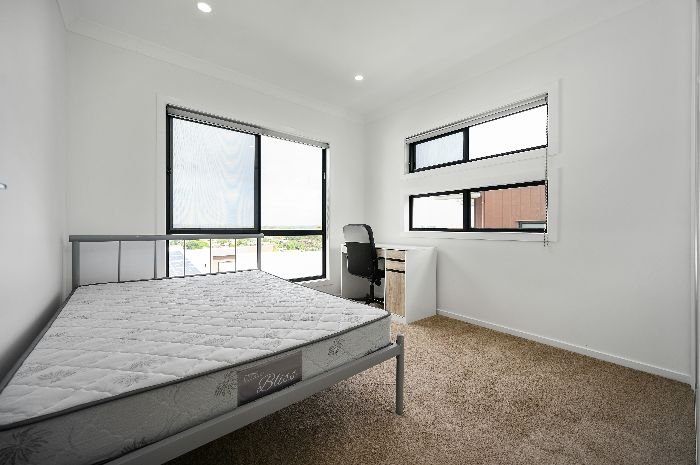 A modern, airy bedroom with a clean mattress, showcasing best practices for daily mattress care and maintaining a fresh sleeping environment.