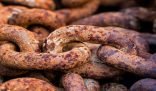 Close-up of heavily rusted metal chains demonstrating the need for rust stain removal techniques.