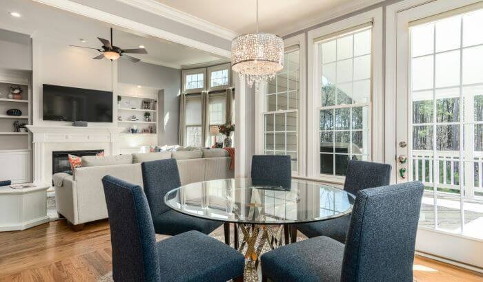 A spacious, well-lit living room with elegant furnishings, highlighting the unique cleaning challenges in large homes.