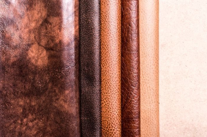 A variety of leather textures side by side, showcasing the results of proper care and maintenance after stain removal to preserve the beauty of leather goods.