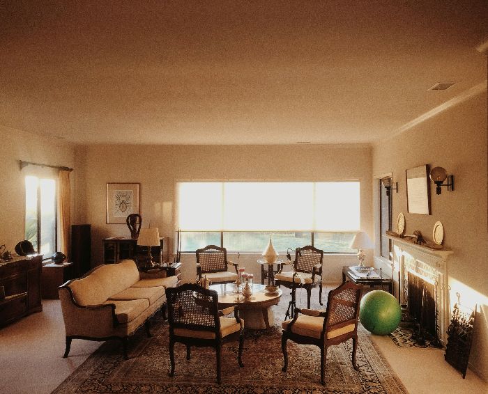 A well-lit living room with furnishings and scattered items, hinting at the subtle social barriers that clutter can create within personal relationships and social settings.