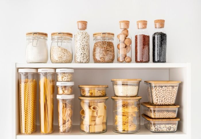 Organized pantry with adjustable shelves and stackable containers, showcasing efficient storage solutions for better pantry organization.