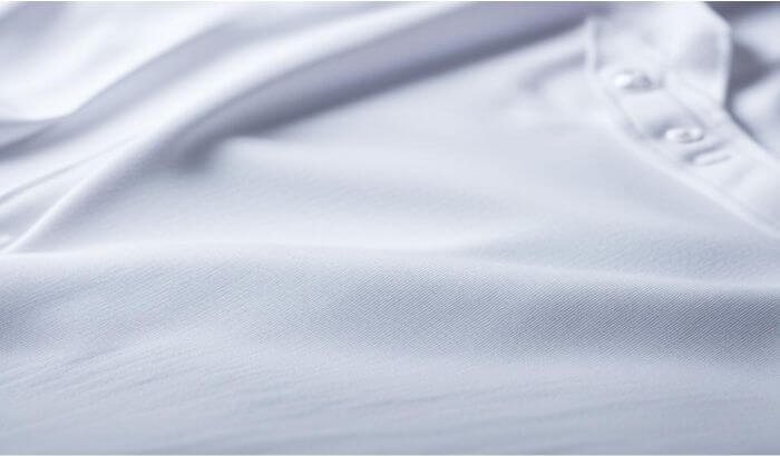 Close-up of a crisp white shirt, highlighting the smooth fabric texture, perfect for a blog post on techniques to remove sweat stains from clothes.
