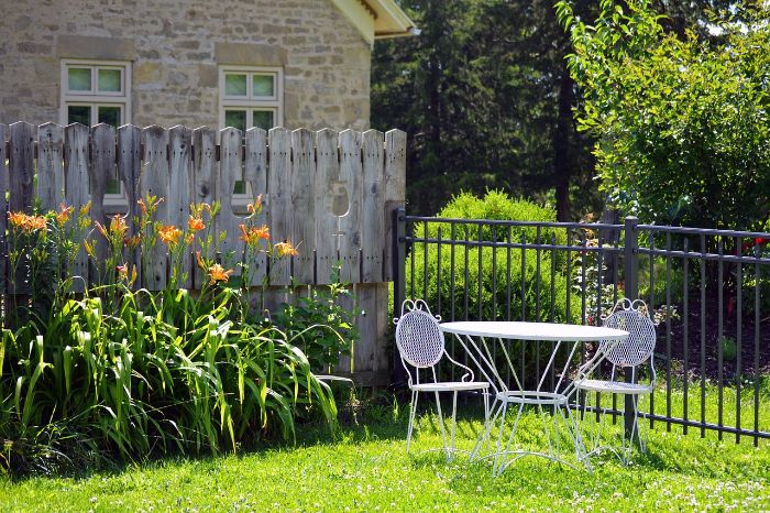 A well-maintained garden with neatly edged lawn and blooming flowers, illustrating effective edging and weed control practices.