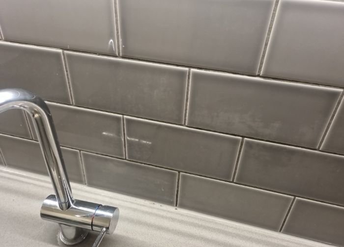 Clean bathroom tiles and fixtures after end of tenancy cleaning in Church End, NW10