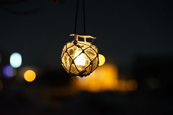 Hanging garden light creating a warm ambiance in the evening, showcasing the use of lighting placement and colors to set a relaxing mood.