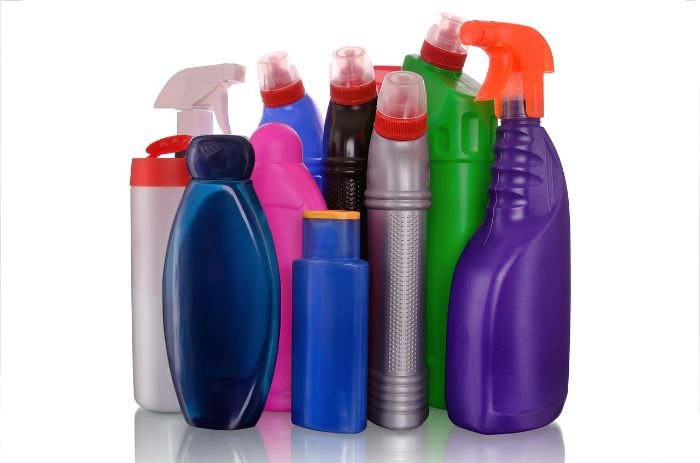Various cleaning product bottles, highlighting the importance of identifying and avoiding harmful ingredients like phosphates, synthetic fragrances, bleach, and ammonia for health and environmental safety.