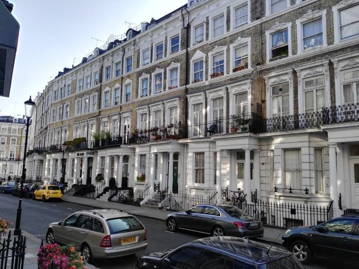 Row of London townhouses representing the importance of market research for pricing adjustments in short-term rentals.