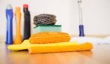 Cleaning supplies including sponges, cloths, and cleaning bottles, symbolizing preparation for the final tenancy cleaning inspection.