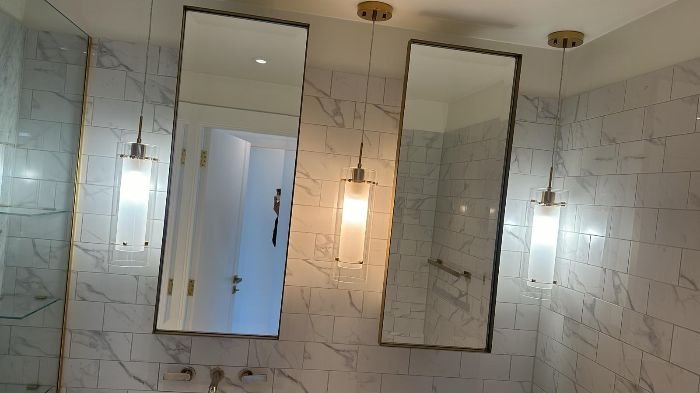 Pristine bathroom with polished mirrors after thorough cleaning