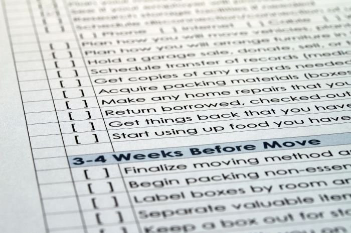 A close-up of a detailed moving checklist, exemplifying the thorough and systematic approach of a professional end of tenancy cleaning service.