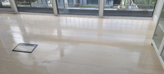 Clean and shiny living area floor with large windows, showcasing the transformation of living spaces during tenancy cleaning in Paddington.