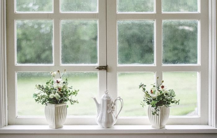 Clean windows with floral decorations, emphasizing the importance of cleaning windows and mirrors for a streak-free, shiny finish.