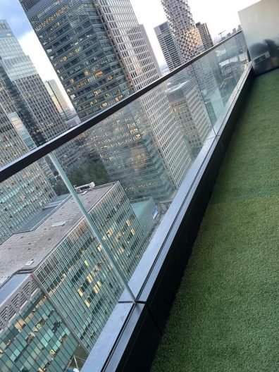 Balcony view of Canary Wharf, E14, after end of tenancy cleaning, overlooking city skyscrapers