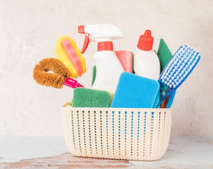 A well-organized cleaning caddy filled with multi-colored sponges, brushes, and spray bottles for efficient home cleaning, exemplifying smart storage solutions for cleaning tools.