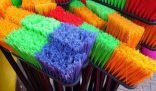 Colorful assortment of brooms displayed, highlighting different types for effective cleaning techniques.