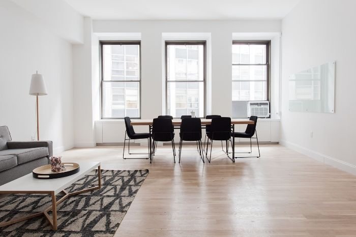 Bright and spacious living and dining area with clean hardwood floors, emphasizing tips on cleaning and protecting floors from high foot traffic during summer.