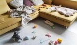 Living room with scattered toys, blankets, and pillows, emphasizing the need for monthly cleaning tasks to keep your home fresh and organized.