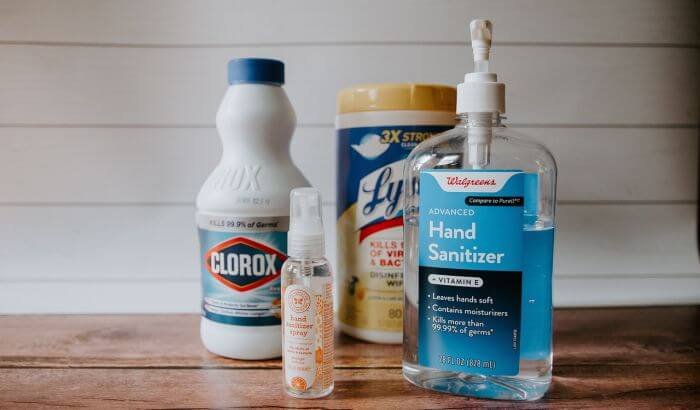 Various multi-surface disinfectants, including hand sanitizer, bleach, and disinfectant wipes, for keeping surfaces germ-free.