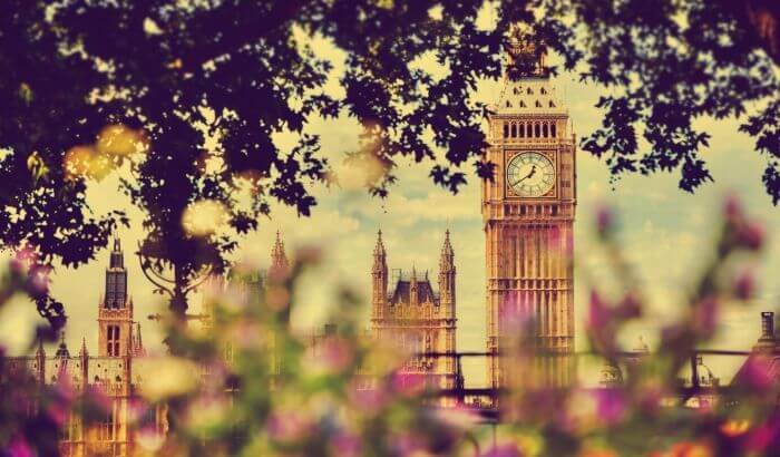 Big Ben and Westminster in spring with blooming flowers, symbolizing the start of seasonal deep cleaning for a fresh home.