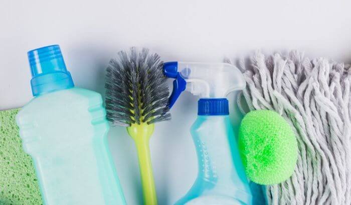 Eco-friendly cleaning supplies, including refillable bottles and brushes, highlighting the shift towards sustainable packaging and refill stations.