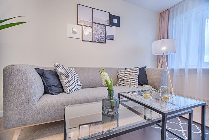 Modern living room with clean curtains, highlighting the importance of choosing the right cleaning methods for different curtain fabrics to maintain air quality and appearance.