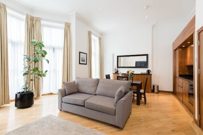 Bright and clean living room in an apartment, illustrating best practices for end of tenancy cleaning to ensure deposit return.