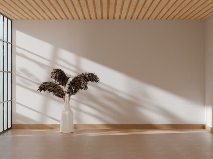 Clean skirting boards in a well-lit room with a vase, showing the importance of cleanliness to avoid deposit deductions at the end of a tenancy.