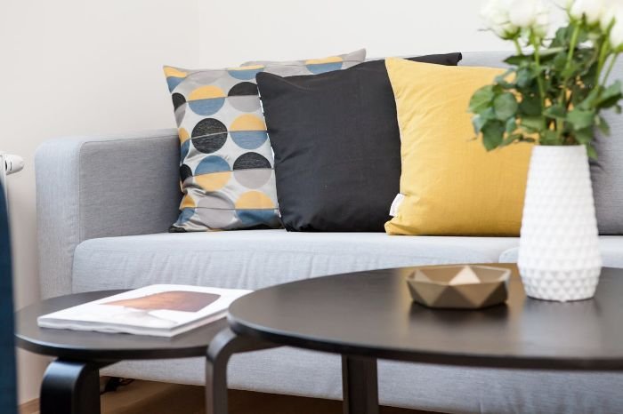 Clean and organized living room with modern decor, highlighting the importance of focusing on common problem areas during end of tenancy cleaning.