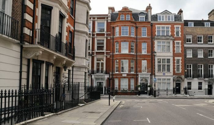 Street view of residential buildings, representing tenant-landlord relationships and guidelines for resolving cleaning disputes.