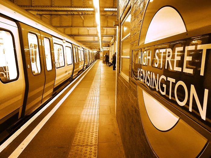 A view of High Street Kensington underground station, symbolizing the role of public transport costs in determining cleaning service prices in London.