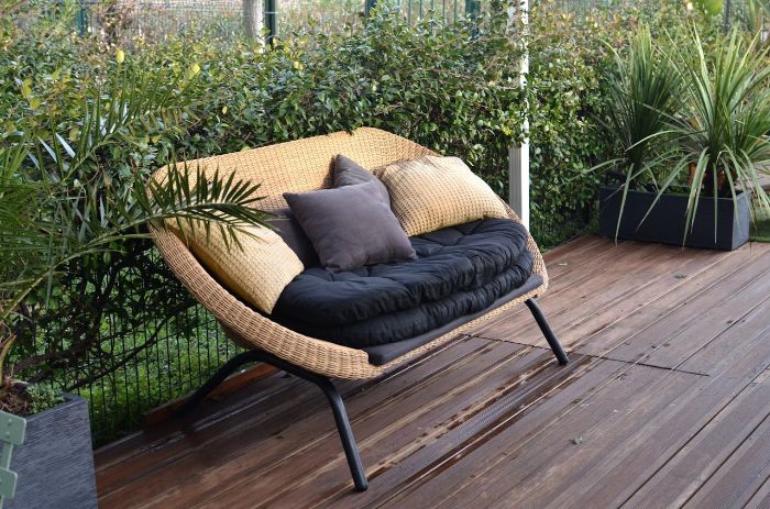 What Happens If You Don’t Clean Your Outdoor Patio and Deck? | What If Series 3 Outdoor patio with clean wooden deck and cozy wicker furniture, highlighting the importance of regular cleaning to maintain aesthetics and prevent grime buildup.