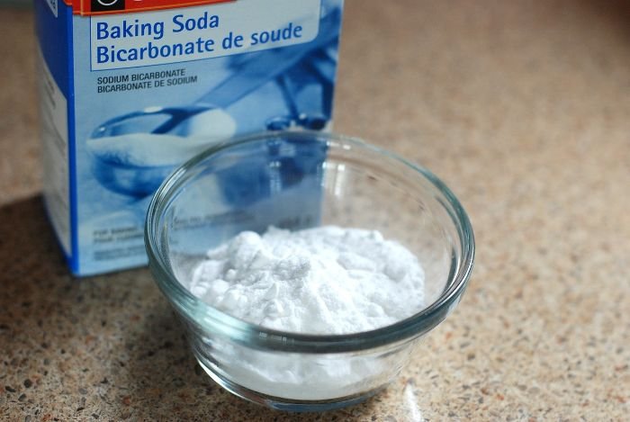 Baking soda in a glass bowl, illustrating natural methods for safely cleaning mold