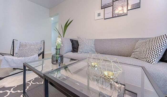 Modern living room with a clean, minimalist setup, representing the high standards of end of tenancy cleaning services in London.