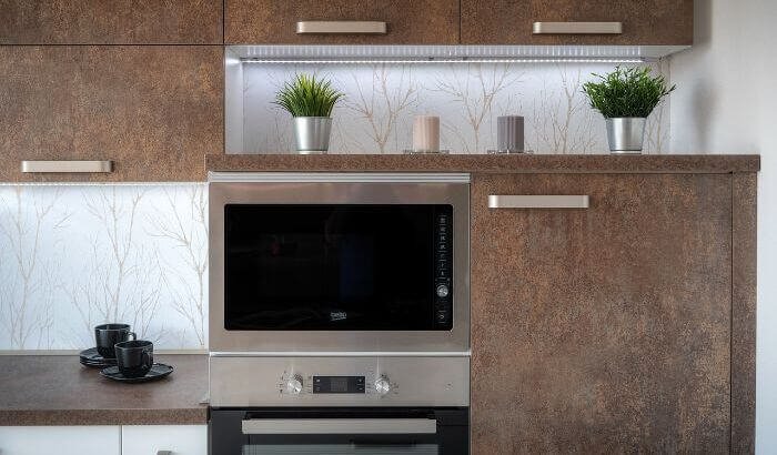 Modern oven in a clean kitchen setup, highlighting the importance of regular oven cleaning to maintain hygiene, performance, and safety.