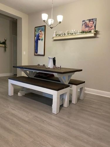 Modern dining area with a wooden table and benches, featuring a clean and organized interior in Covent Garden, WC2.