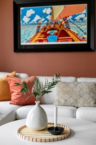 Elegant living room decor with a vase, candle, and framed artwork, showcasing a clean and inviting atmosphere in Chigwell, IG7.
