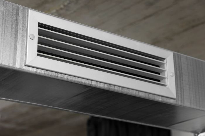 Clean air vent installed on a ceiling, emphasizing the importance of regular maintenance for better air quality and energy efficiency in homes.