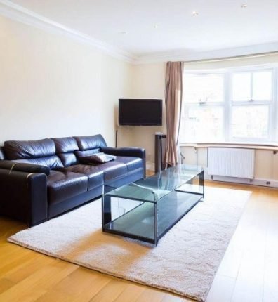 Bright and modern living room with a clean black sofa and glass coffee table, professionally cleaned during end of tenancy cleaning in Covent Garden, WC2.