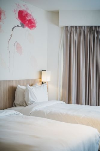 Fresh and spotless bedroom with neatly made beds and modern decor after professional end of tenancy cleaning in Barnsbury, N1.