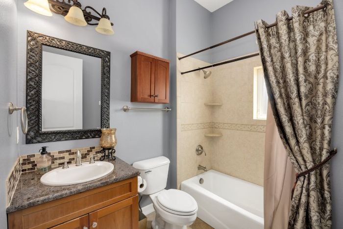 A clean and organized bathroom with a shower curtain liner. Emphasizes the importance of keeping curtain liners free from mould and bacteria in a high-moisture environment.