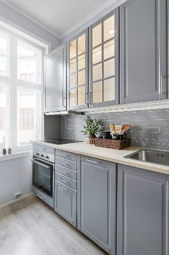 Modern kitchen with grey cabinets and a clean countertop after professional end of tenancy cleaning in Clapham Junction, SW11.