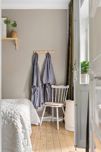 Clean and organized bedroom after professional end of tenancy cleaning in Manor House, N4, featuring polished wooden floors, fresh bedding, and cozy decor.