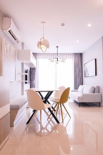 A bright and modern apartment with a dining area and living space, featuring clean floors and stylish furnishings, representing a professionally cleaned home in Barnes, SW13.