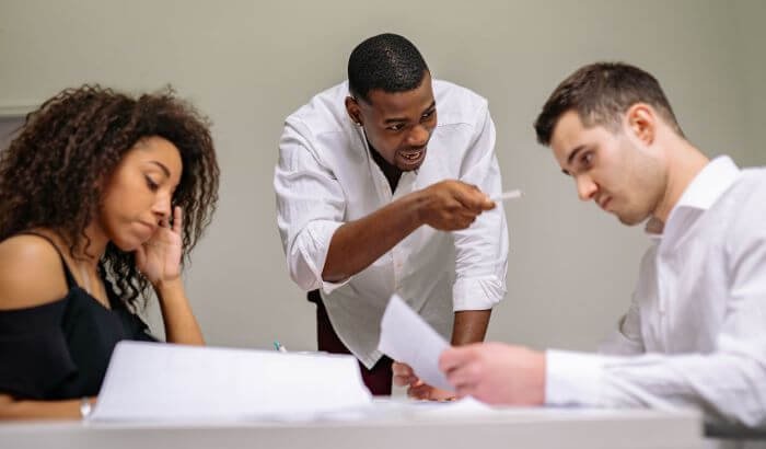 A landlord disputing with tenants over paperwork, illustrating concerns about end of tenancy cleaning and landlord dissatisfaction.