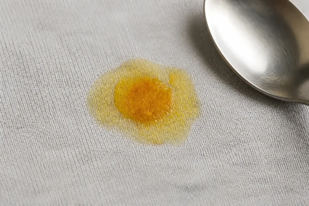 How to Remove Curry Stains with No-Nonsense Methods and Strategies 6 Oily outer ring and turmeric pigment in a fresh curry stain on cotton